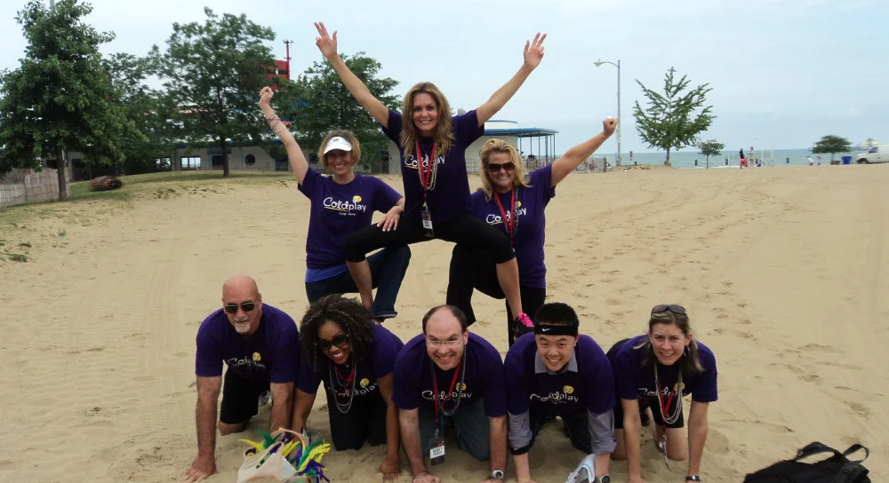 Guests in a human pyramid at one of our scavenger hunt locations on the beach in chicago